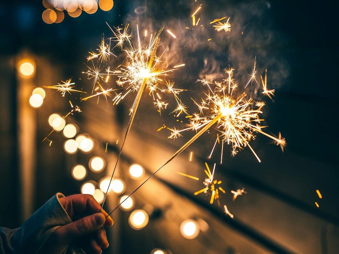 a person holding a sparkler in their hand