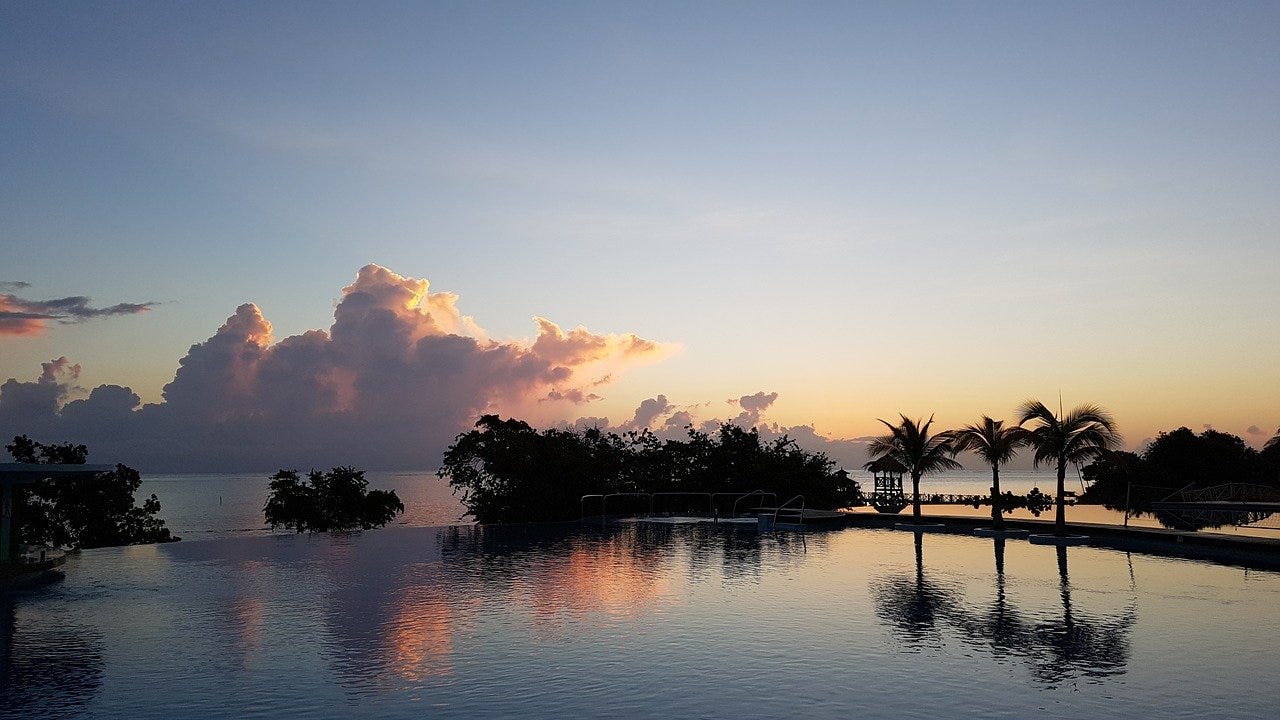 Jamaican sunrise and sky reflected in the water