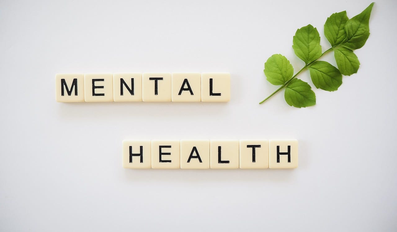 scrabble tiles spell out 'mental health'