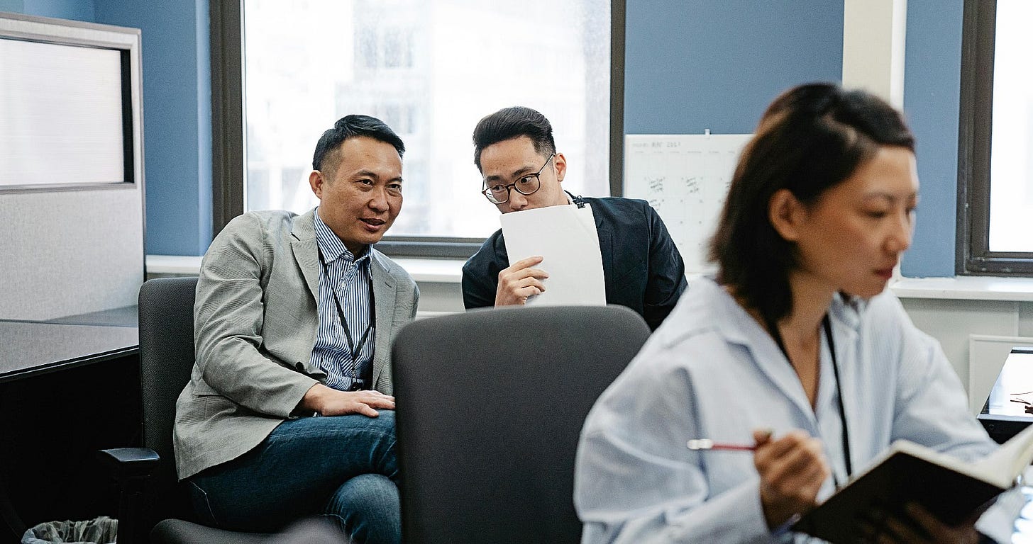 two businessmen gossip[ over a colleague two businessmen gossip[ over a colleague