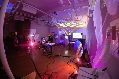 Images of artists working with computers and projectors in an art gallery