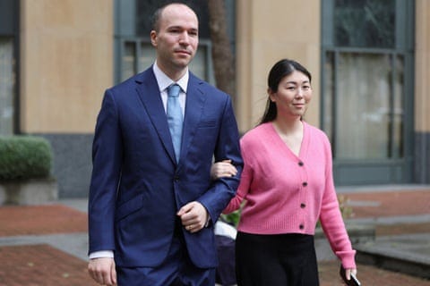a man and a woman walk together outside