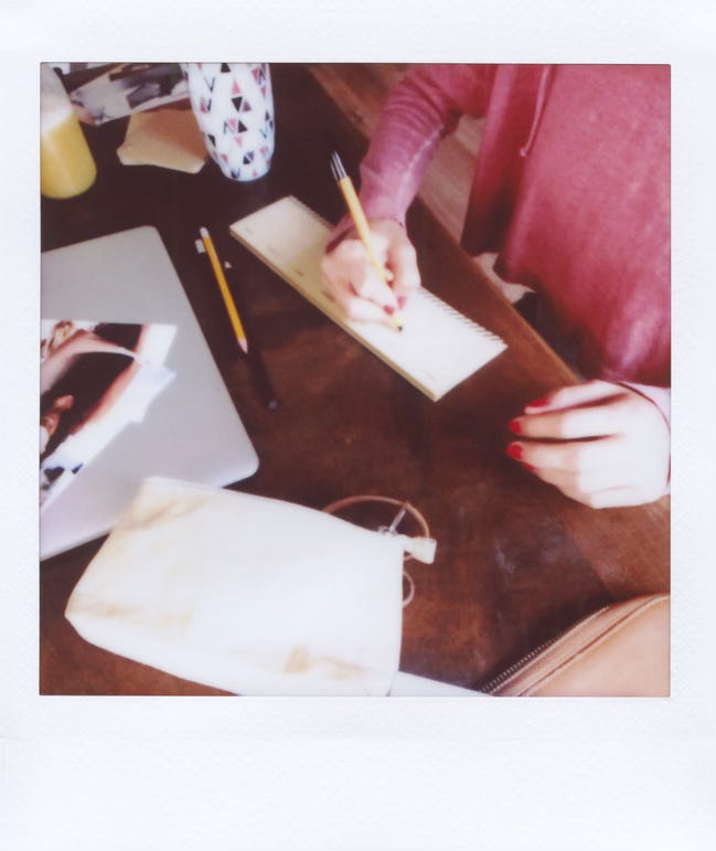 postcard with someone writing on a desk