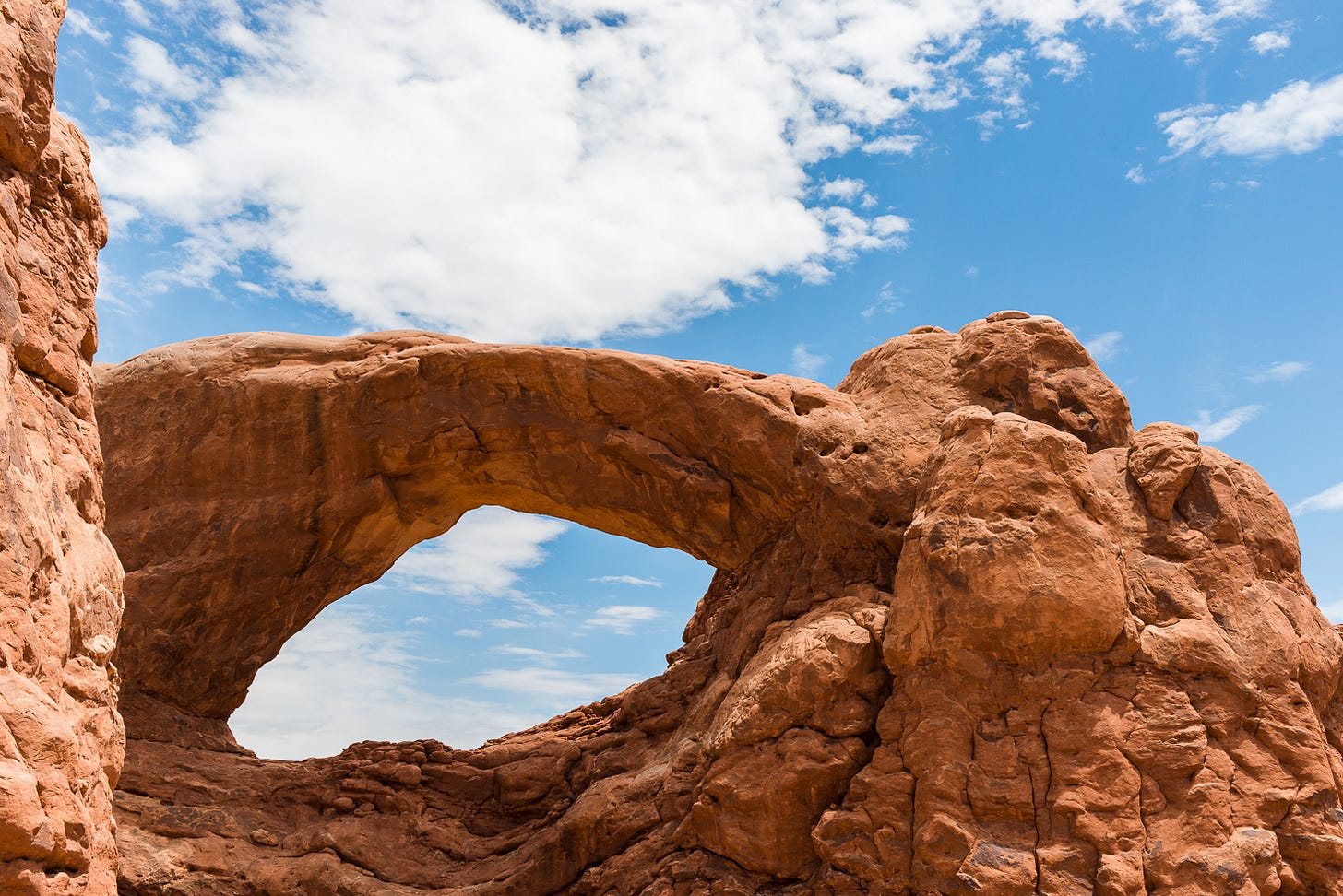 Rock archway framing the sky.