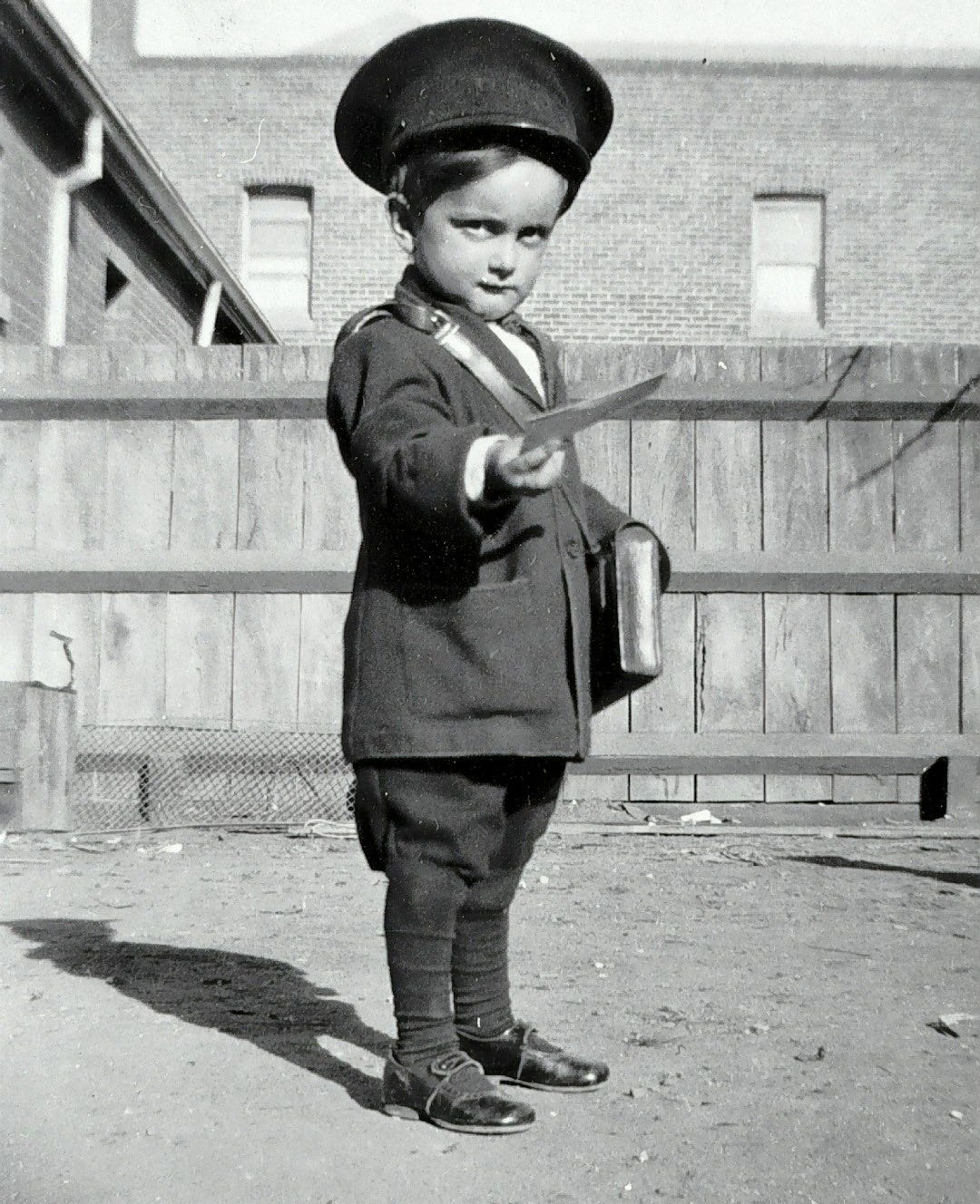 boy in black long sleeve shirt holding a stick
