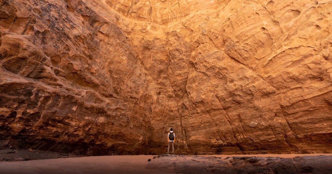 a man standing in the middle of a canyon