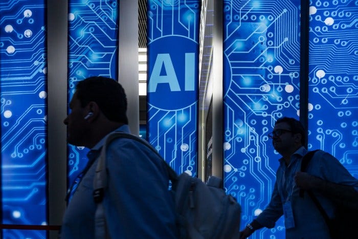 Attendees walk past AI signage at the Canton Fair. Attendees walk past AI signage at the Canton Fair.