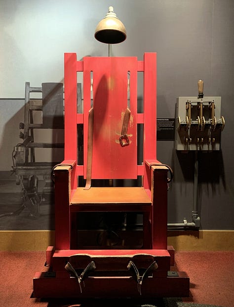 Photo of An electric chair at the Mob Museum in Las Vegas, Nevada; photo of a small "hand guillotin"