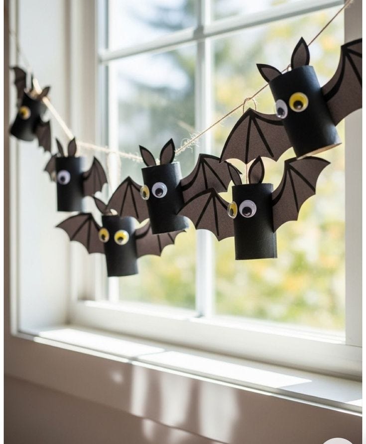 This may contain: paper bats hanging from a window sill