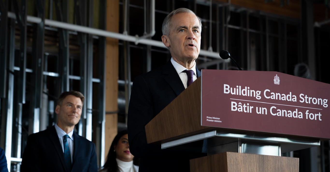 Prime Minister Carney at a podium in Brampton, Ontario.