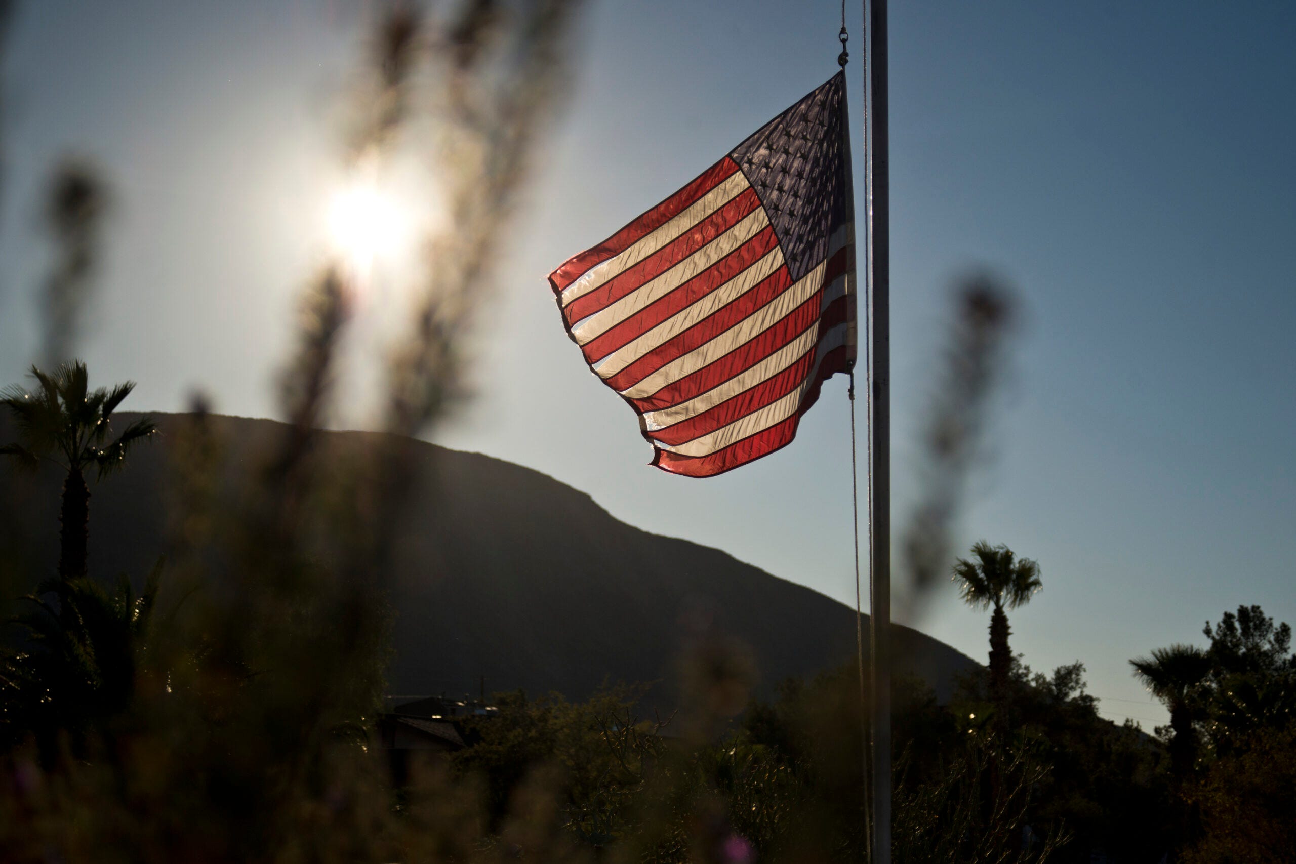 American flags at half-mast symbolizing unity, hope, and shared responsibility