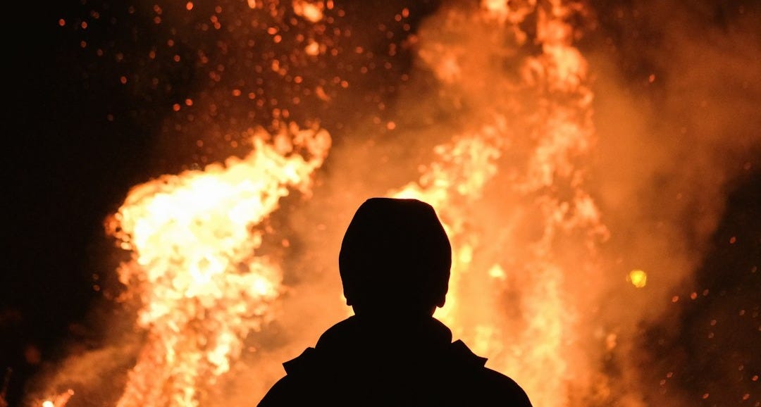 person standing in front of fire person standing in front of fire