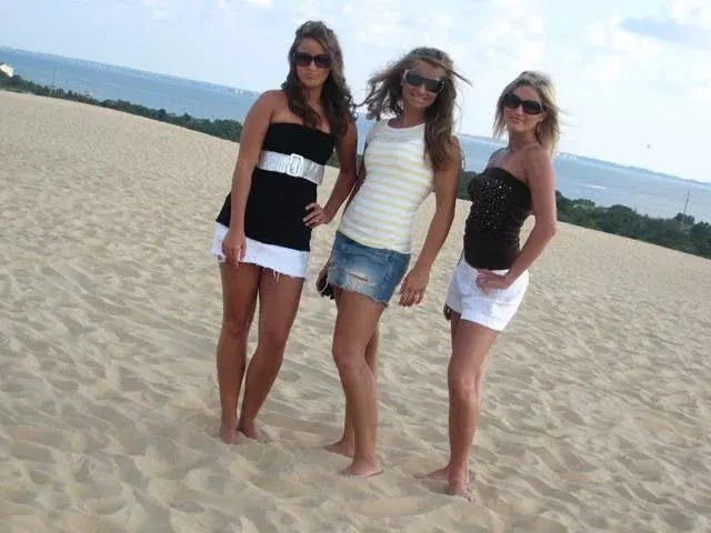 A classic 2000s ensemble: bohemian skirts, embroidered tunics, and trendy streetwear sneakers all paired together.