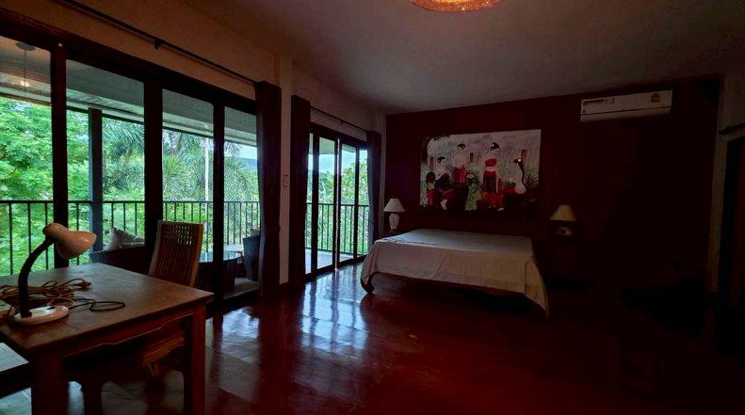 Bedroom with sliders opening to the forest