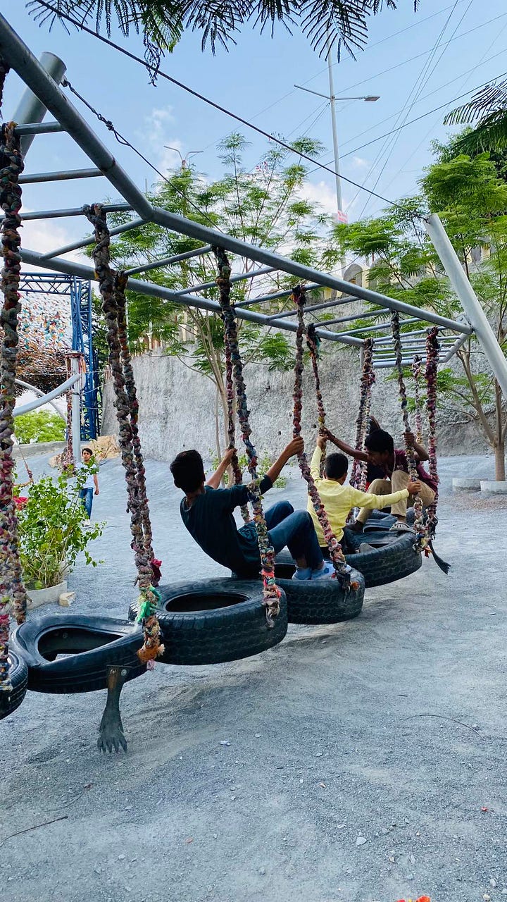Children playing on swings at Udaan Park, Udaipur, Rajasthan
