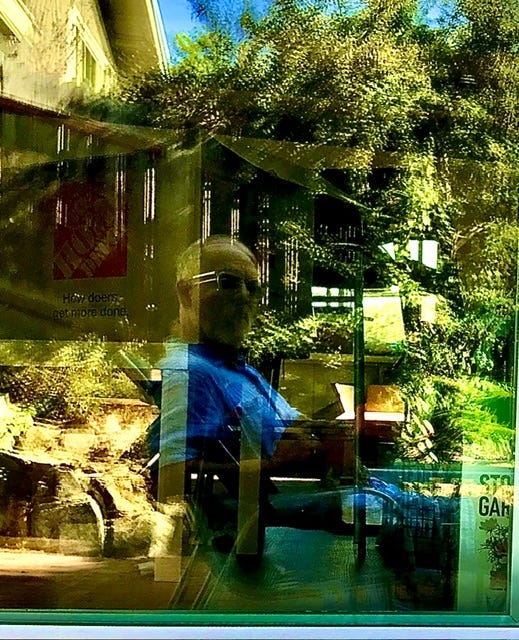 Faux Jean in the wild, reflected off the glass door of the patio of his new rental.