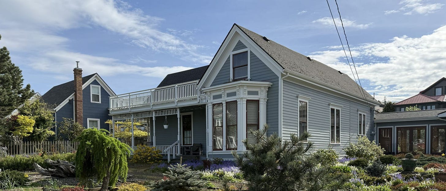 A two-story house with a canted bay on the first floor and two stories of wrap-around porches.