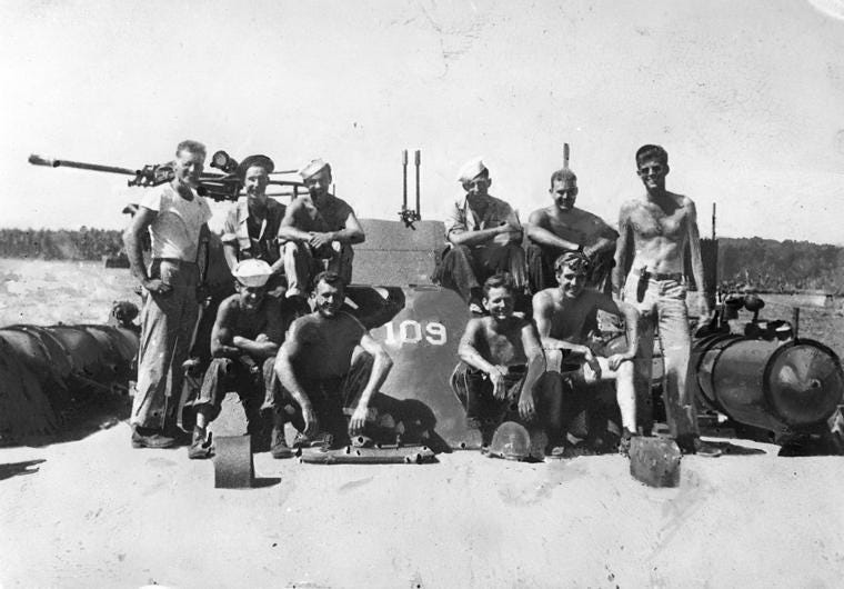 John F. Kennedy and crewmen of PT-109. Back Row (L-R) Allan Webb, Leon Drawdy, Edgar Mauer, Edmund Drewitch, John Maguire, Lt. (jg) John F. Kennedy (standing, far right).