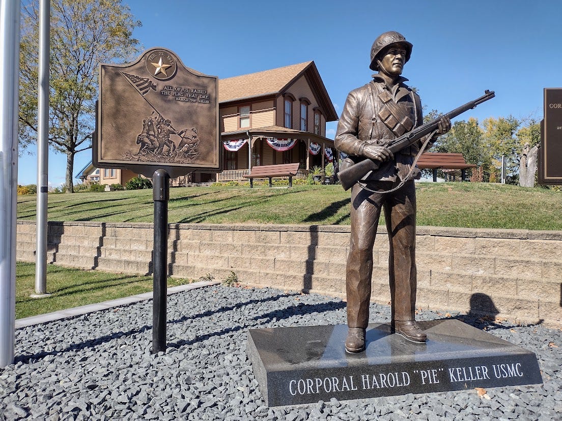 Statue of marine and plaque showing flag-raising