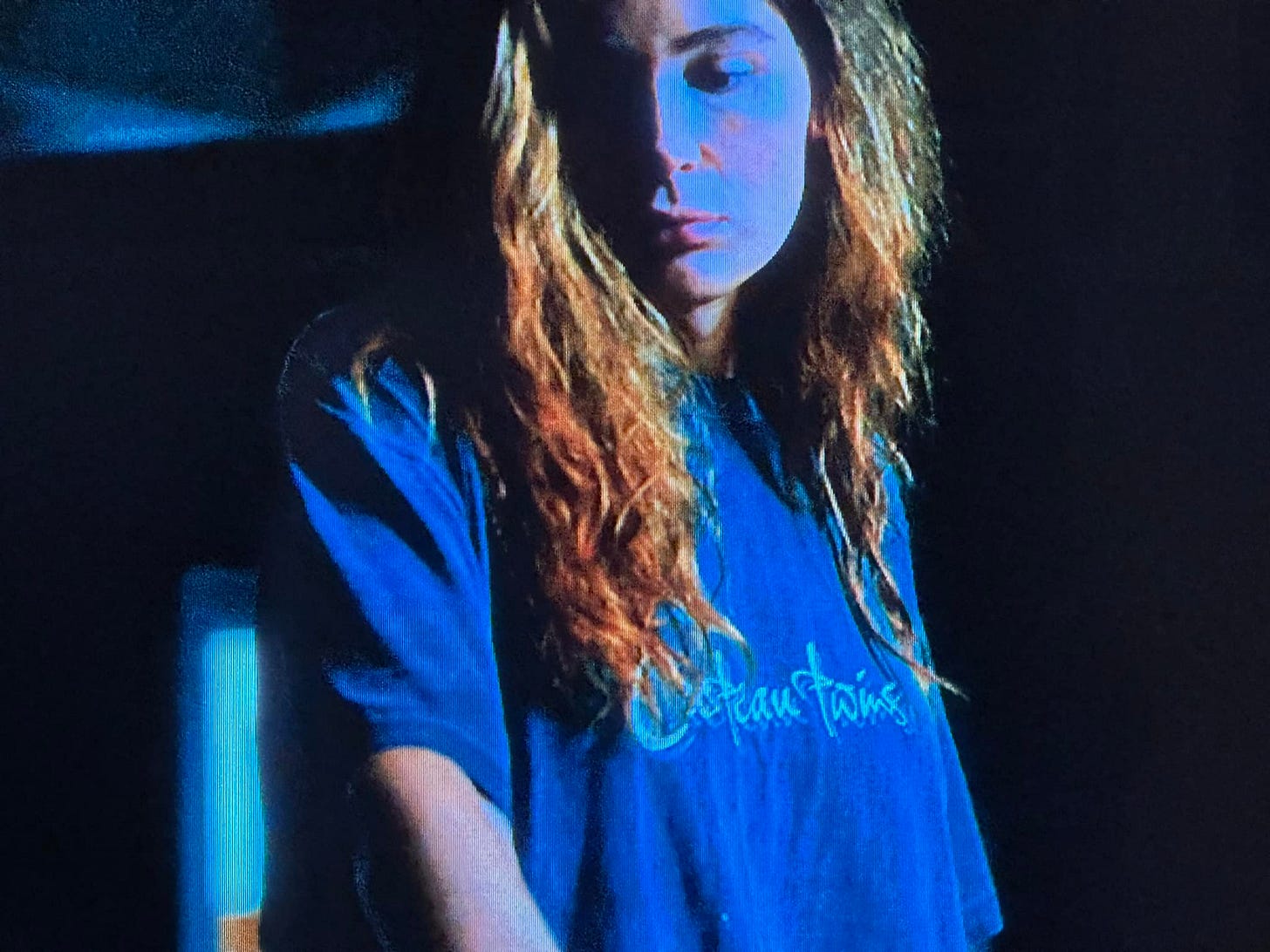 Screen capture of a woman wearing a Cocteau Twins t-shirt.