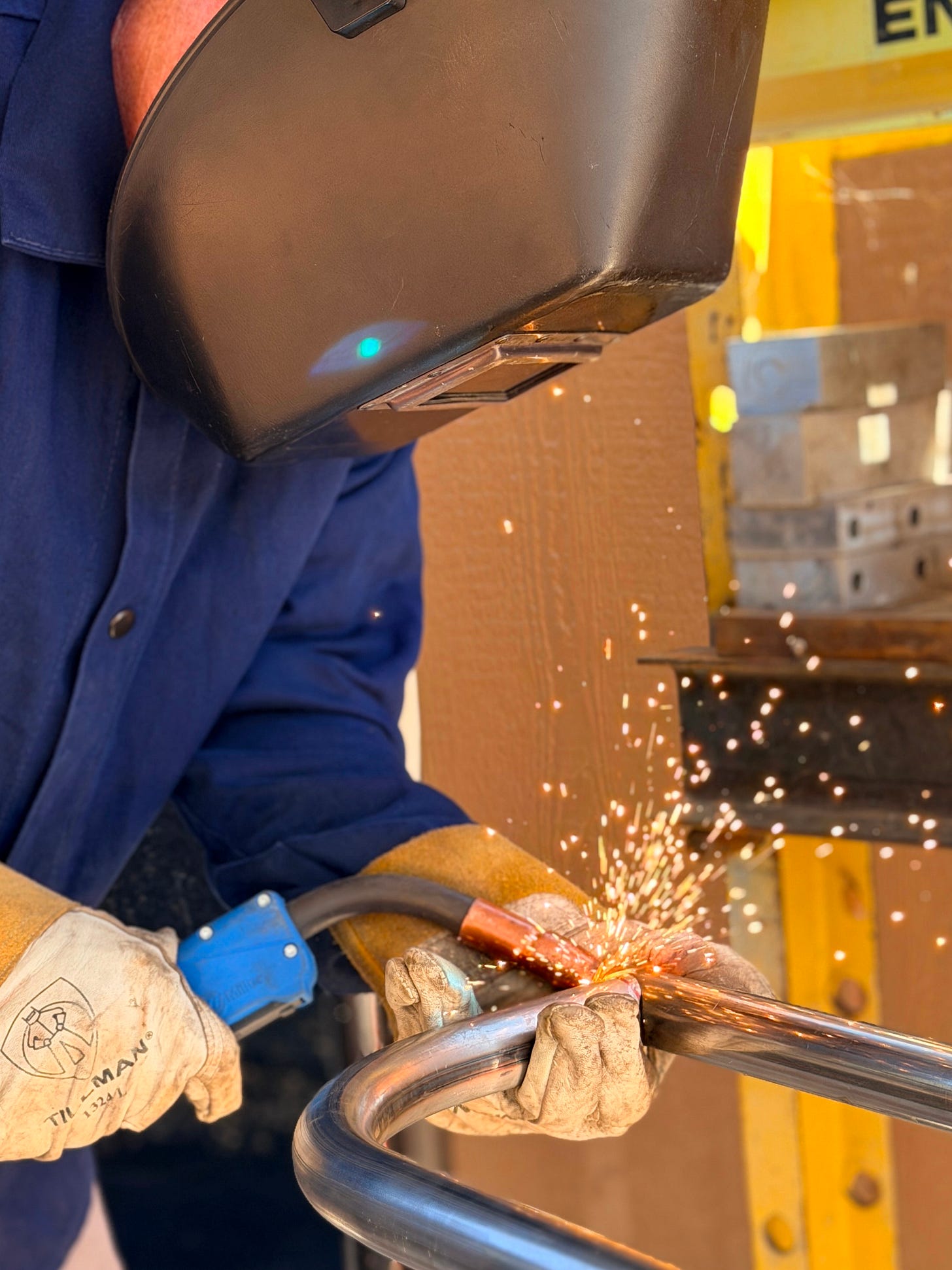 Welder MIG welding two steel pieces. Welder MIG welding two steel pieces.