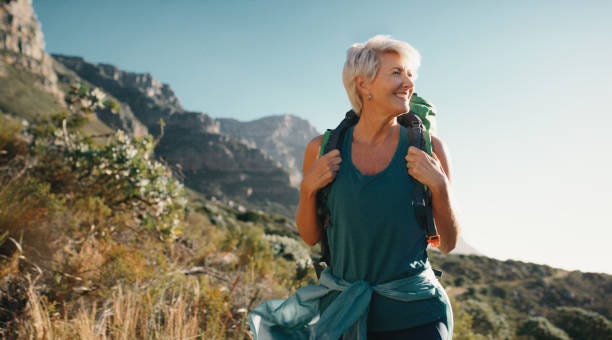 Hiking, relax and senior woman with smile in forest, woods or nature for peace, trekking or outdoor adventure. Mountain view, retirement or hiker in park for travel or wellness on holiday vacation Hiking, relax and senior woman with smile in forest, woods or nature for peace, trekking or outdoor adventure. Mountain view, retirement or hiker in park for travel or wellness on holiday vacation Middle-aged women stock pictures, royalty-free photos & images