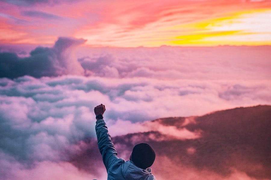 Person with fist in the air at sunrise Person with fist in the air at sunrise
