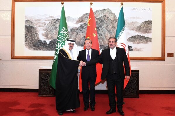 In this photo released by Xinhua News Agency, Ali Shamkhani, then secretary of Iran's Supreme National Security Council, right, shakes hands with Saudi national security adviser Musaad bin Mohammed al-Aiban, left, as Wang Yi, China's most senior diplomat, looks on for a photo during a closed meeting held in Beijing, on March 11, 2023. (Luo Xiaoguang/Xinhua via AP, File) In this photo released by Xinhua News Agency, Ali Shamkhani, then secretary of Iran's Supreme National Security Council, right, shakes hands with Saudi national security adviser Musaad bin Mohammed al-Aiban, left, as Wang Yi, China's most senior diplomat, looks on for a photo during a closed meeting held in Beijing, on March 11, 2023. (Luo Xiaoguang/Xinhua via AP, File)