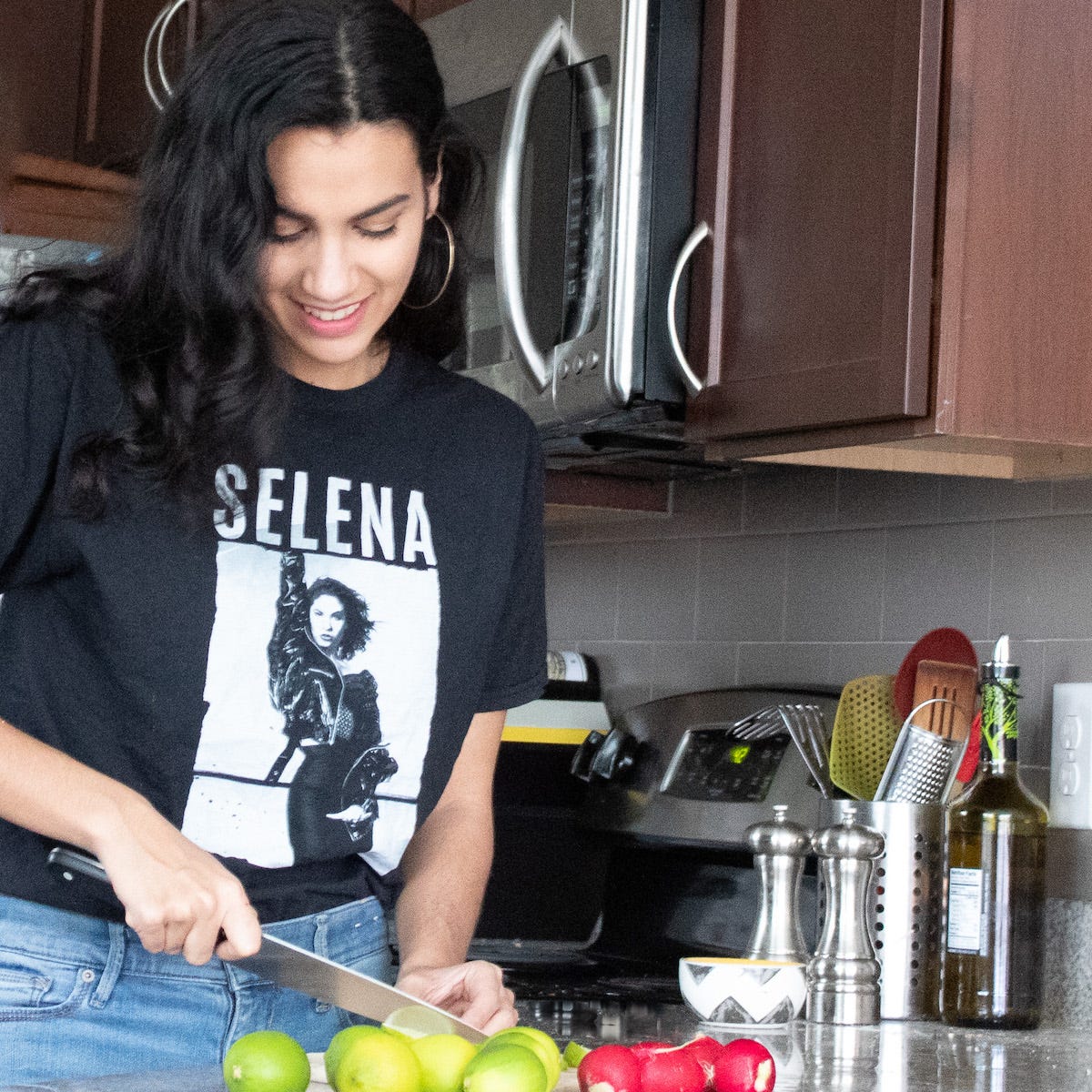 Krista Linares cutting limes in her kitchen