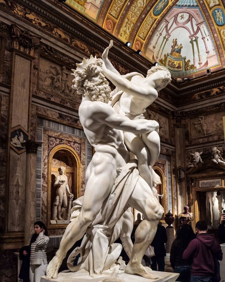 This may contain: a group of people standing around a statue in a building