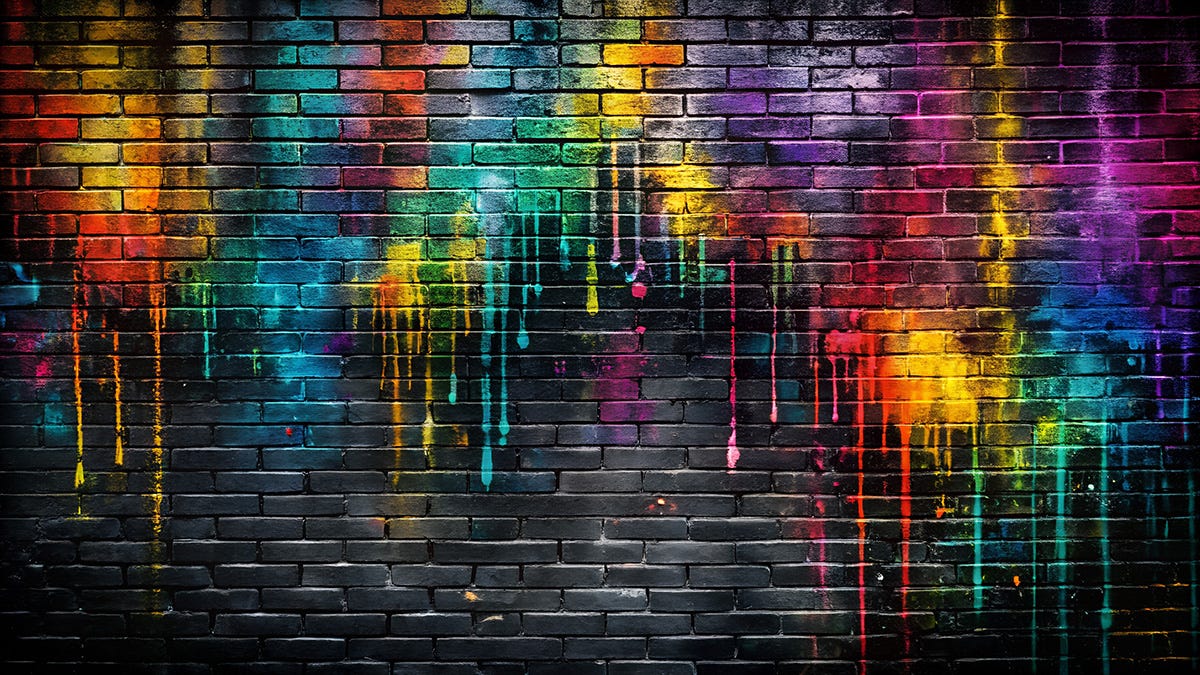 Image of a black brick wall covered with multicolour dripping paint splatters Image of a black brick wall covered with multicolour dripping paint splatters
