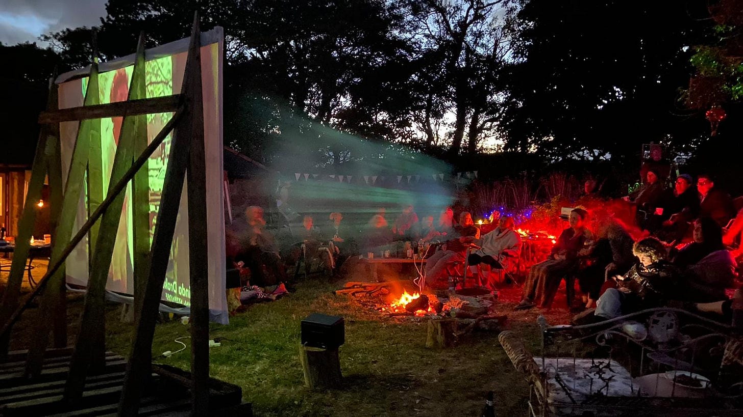 outdoor film screening around open fire
