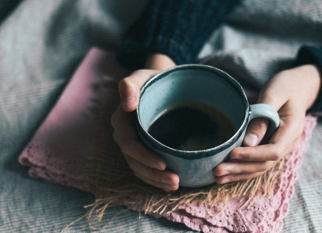 person holding green mug