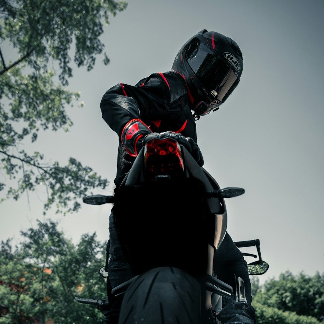 man in black leather jacket riding black motorcycle man in black leather jacket riding black motorcycle