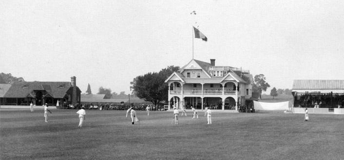 Black and white photo of a cricket game in the 1880s