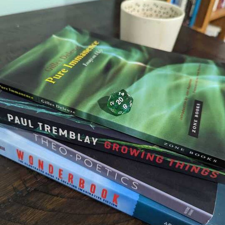 Upper left: Books with dice. Upper Right: Concept art for my fantasy novel. Lower Left: A map I'm working on. Lower Right: More books, with Tarot.