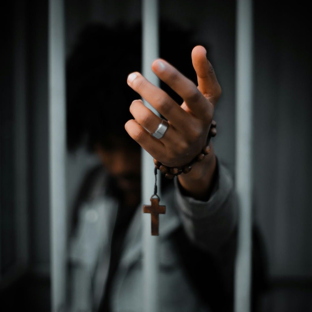 man holding rosary man holding rosary