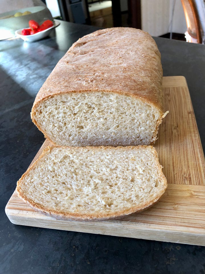 A cheesecake and a loaf of bread