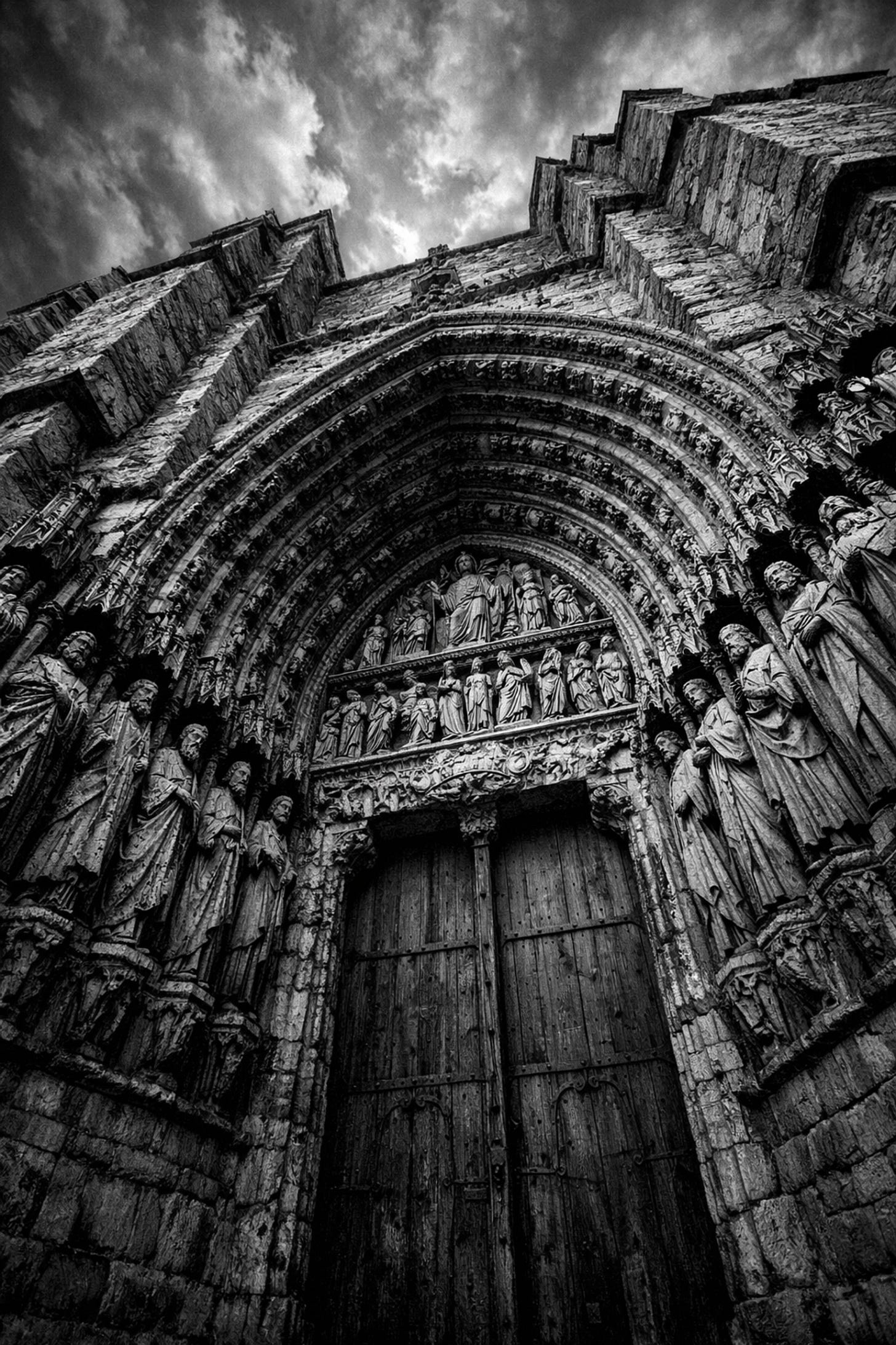 Ancient stone cathedral entrance showing the timeless nature of Catholic tradition and history.