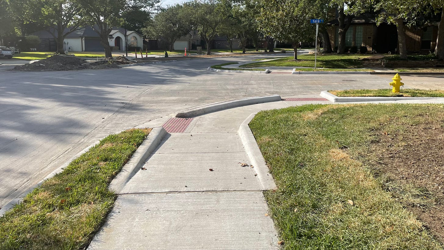 A street corner with a directional curb in the middle