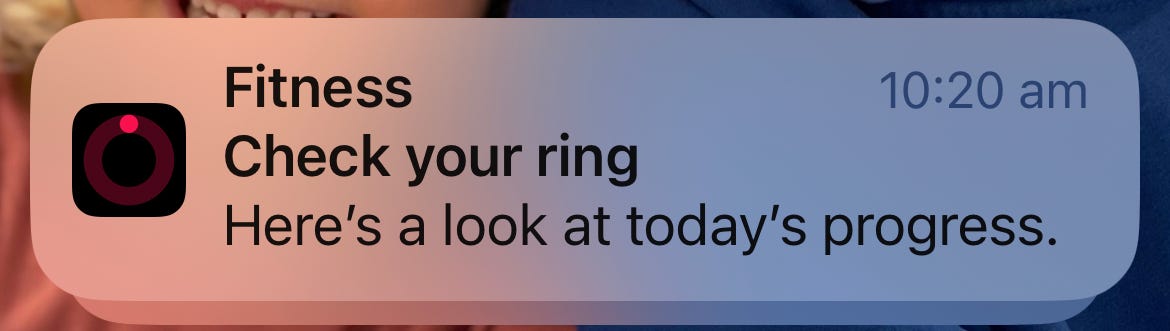 Screenshot of Iphone message reading:  Fitness - Check your ring - here's a look at today's progress Screenshot of Iphone message reading:  Fitness - Check your ring - here's a look at today's progress