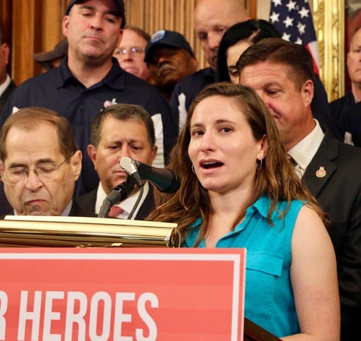 Lila speaking at a Congressional Press conference in 2019 next to members of Congress on the day the Zadroga Act Extension passed in the house Lila speaking at a Congressional Press conference in 2019 next to members of Congress on the day the Zadroga Act Extension passed in the house
