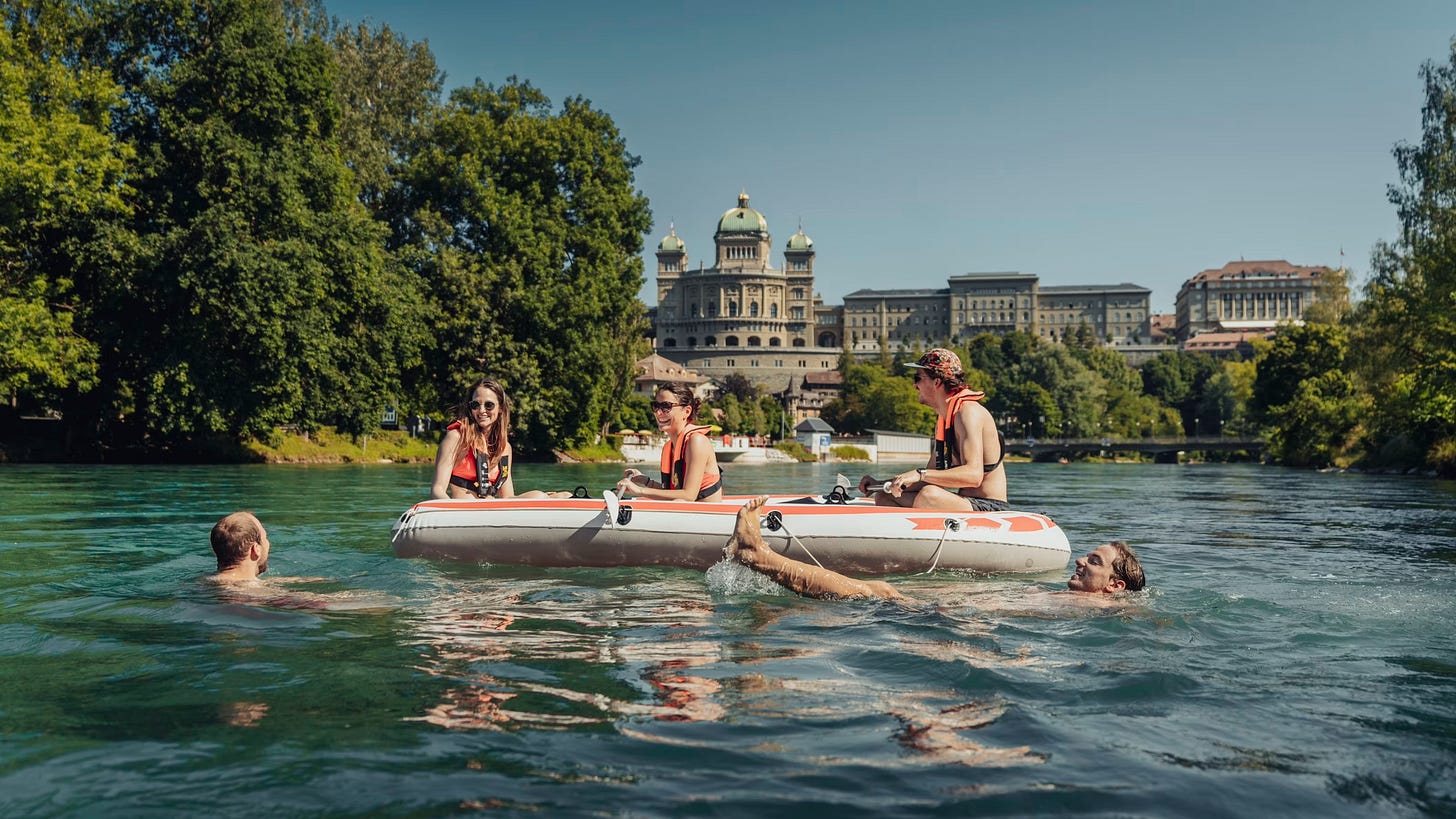 Swimmers enjoying floating down the River Aare.
