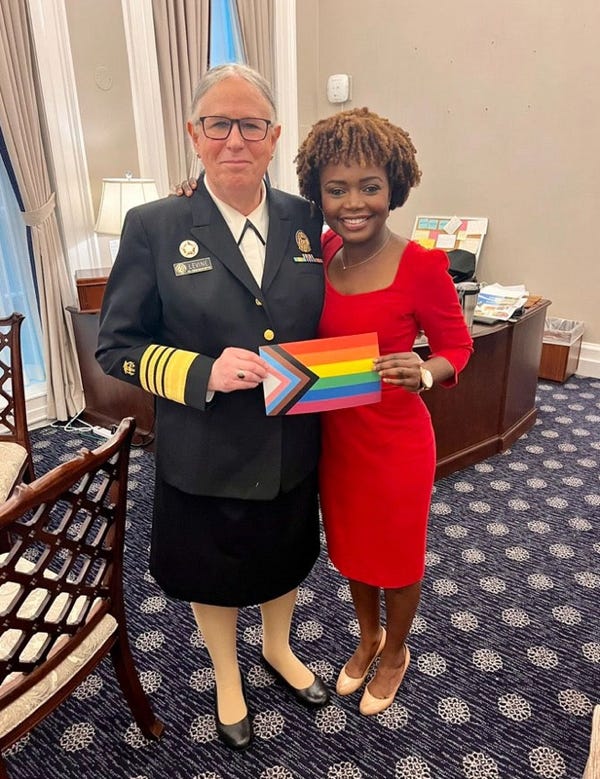 A person in a uniform holding a rainbow flag and a person in a red dress

AI-generated content may be incorrect.
