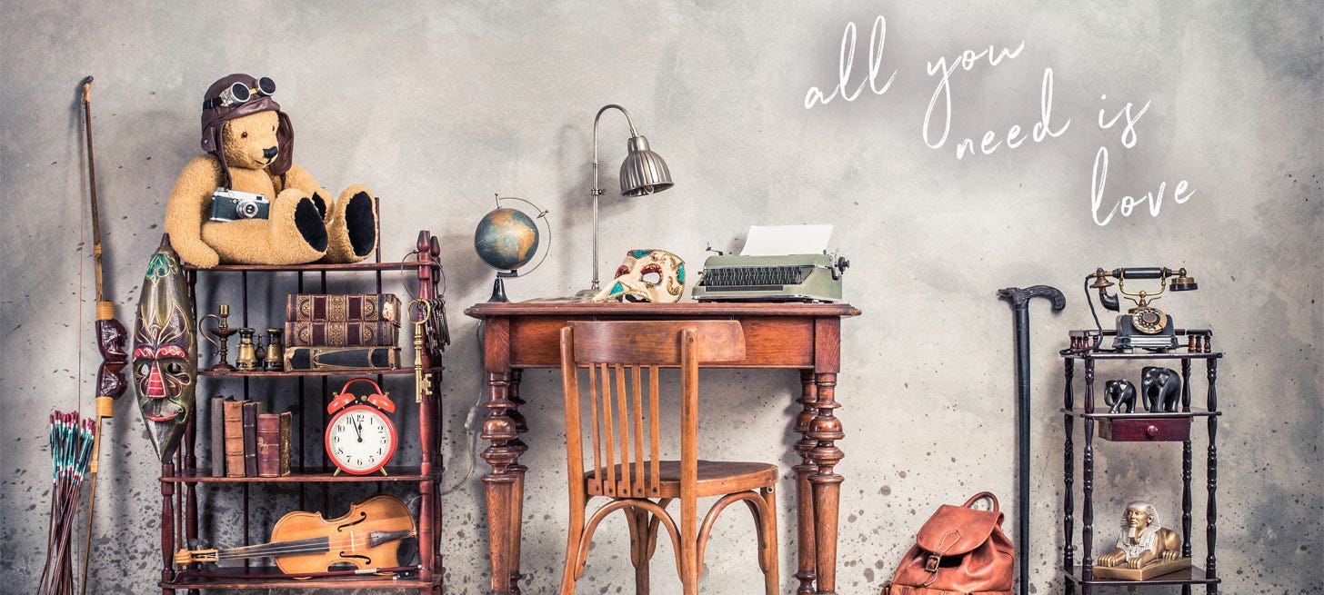 Writer's room with knickknacks from world travels and "All you need is love" written on the wall.