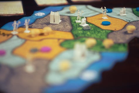 Spirit Island, For Science!, and Through the Desert, each in varying states of play.