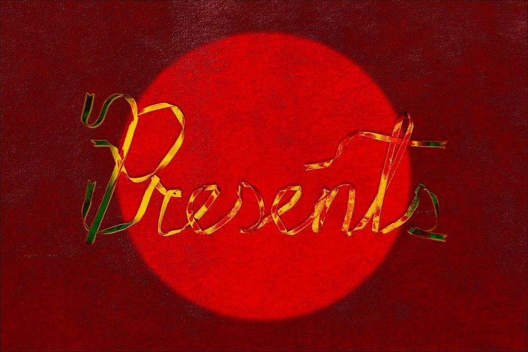 Against a red backdrop that might be velvet, there’s a spotlight. Spilling just out of the circle is the word “Presents,” spelled with thin, fancy, shiny yellow or gold ribbon, like something special was just unwrapped.