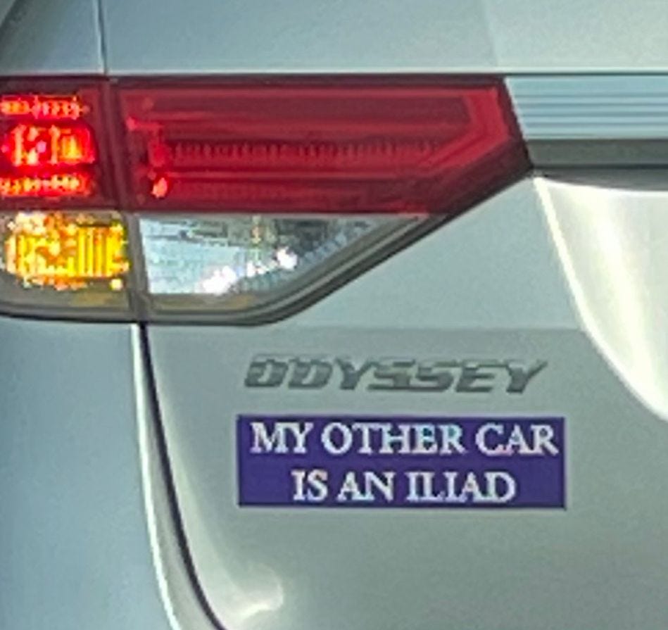 A bumper sticker just below where the car says Odyssey reading “my other car is an Iliad” A bumper sticker just below where the car says Odyssey reading “my other car is an Iliad”