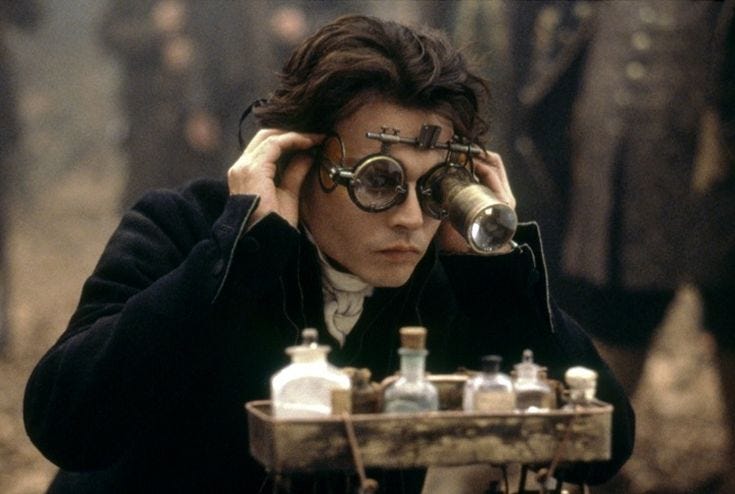 This may contain: a man with glasses looking at bottles on a table while holding his head in one hand