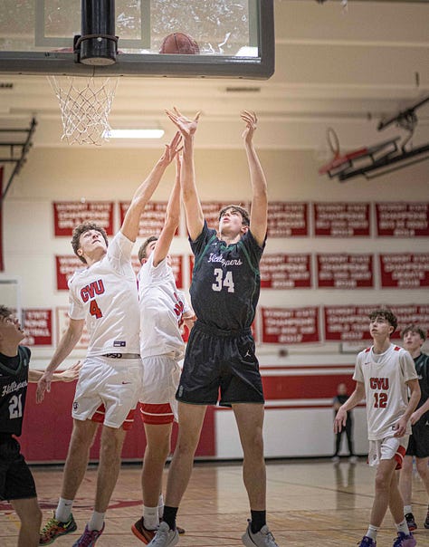Five pictures of CVU boys basketball players in various stages of leaping and shooting with the ball. White uniforms with red lettering.